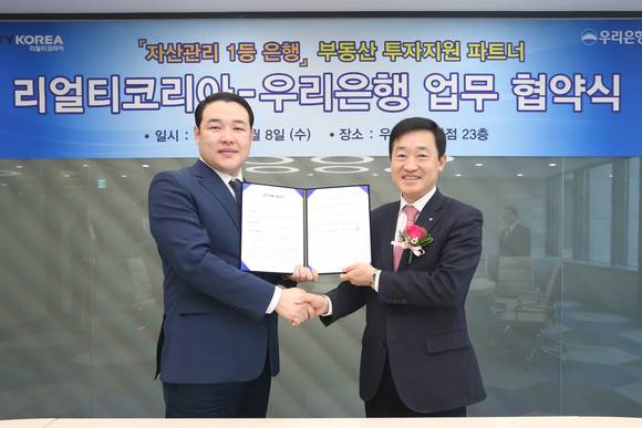 ▲ 우리은행은 지난 8일 본점에서 정채봉 상무(오른쪽)와 리얼티코리아 유진석 대표가 참석한 가운데 업무 협약식을 체결했다.ⓒ우리은행