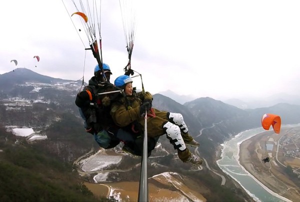 ▲ 단양을 찾은 젊은이들이 두산마을에서 페러를 타고 하늘을 날으며 스릴를 만끽하고 있다.ⓒ단양페러마을