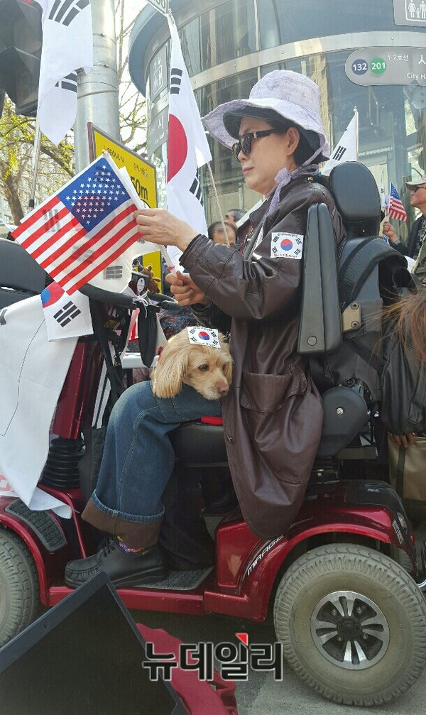 ▲ 15일 오후 서울 중구 대한문 앞에서 개최된 태극기집회에 한 시민이 태극기와 성조기를 들고 참석했다. ⓒ 뉴데일리 임혜진 기자