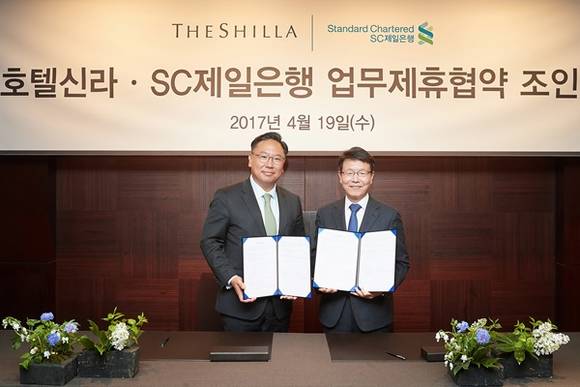 ▲ 지난 19일 서울 장충동 신라호텔에서 SC제일은행 윤패트릭 부행장(왼쪽)과 호텔신라 김청환 부사장(오른쪽)이 업무제휴 양해각서를 체결했다. ⓒSC제일은행