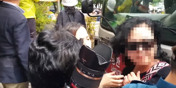 자유한국당 홍준표 후보의 8일 유세 도중 칼을 들고 난입한 여성이 경찰에 둘러싸여 있다. ⓒ유투브 화면 캡처