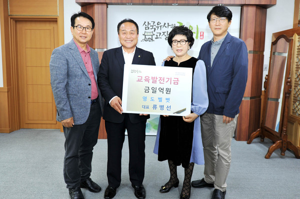 ▲ 류병선 영도벨벳 대표(왼쪽 세번째)가 지난 7일 군위군청에서 김영만 군위군수(왼쪽 두번째)에게 교육발전기금을 전달했다.ⓒ군위군