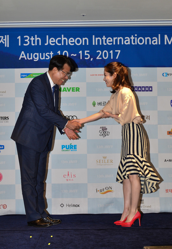 ▲ 이근규 제천시장이 18일 제13회 ‘제천국제음악영화제’ 홍보대사 배우 한지민에게 위촉패를 수여하고 악수를 나누고 있다.ⓒ제천시