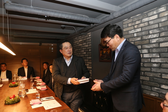 구자열 LS  회장(왼쪽)이 LS전선 부스덕트 사업부 김우태 이사에게 신규임원을 대표해 불타는 투혼 책을 선물하고 있다.ⓒLS