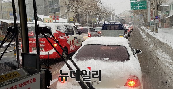 ▲ 9일 오전 빙판길을 이룬 충북 청주시 상당구 육거리시장 인근 도로에는 거대한 주차장을 방불케 한 가운데 많은 차량들이 신호대기를 기다리고 있다.ⓒ김정원 기자