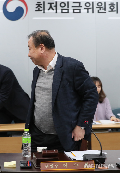 ▲ 지난달 31일 정부세종청사에서 열린 최저임금위원회 2차 전원회의에서 1월 27일 조선일보 인터뷰 발언이 사용자(경영계) 측에 편향됐다는 이유로 노동계 위원들로부터 사퇴 압박을 받은 어수봉 위원장이 자리를 뜨고 있다. 최저임금위는 설 연휴가 끝난 20일 3차 전원회의에서 최저임금 산입범위 개편 논의를 이어갈 예정이다. ⓒ뉴시스