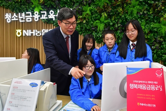 ▲ 이대훈 농협은행장(왼쪽 두번째)이 지난 3일 서울시 중구 농협은행 본사에 위치한 청소년 금융교육센터에서 경기도 관내 중학생 60여명을 대상으로 실시한 행복채움금융교실에서 일일교사로 수업을 진행하고 있다.ⓒ 농협은행