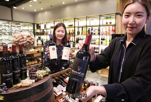 ▲ 현대시티아울렛 동대문점 지하 2층 와인매장에서 직원들이 '와인 창고 대 개방전'에서 선보일 특가 와인들을 선보이고 있다. ⓒ현대백화점