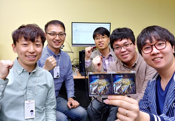 ▲ 사진은 VR 기술 연구에 참여한 연구원들이 파이팅을 하고 있는 모습. 좌측 앞쪽부터 LG디스플레이 OLED알고리즘팀 이호철 선임, 이상린 책임, 서강대 강석주 교수(뒷편 가운데), 강건우 학생, 장정우 학생.ⓒLG디스플레이