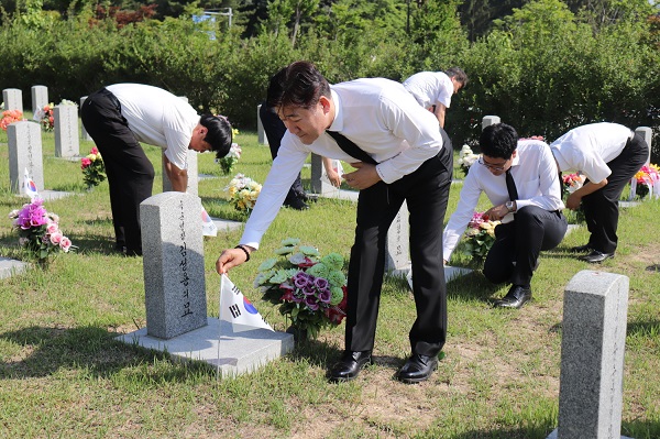 맥키스컴퍼니 임직원들이 1일 대전현충원에서 묘역에 태극기 꽂기 봉사를 하고 있다. ⓒ맥키스컴퍼니