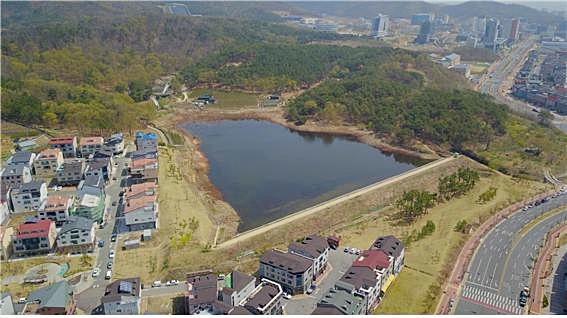 ▲ 대구 혁신도시 새론중학교 서쪽 편에 있는 나불지는 면적이 3만여㎡ 달하는 저수지로서 예전에는 농업용 저수지로 사용돼 왔으나 현재는 방치된 상태로 주민들이 산책로 등으로 조성해 줄 것을 건의해 왔다.(사진은 나불지 일원 항공사진)ⓒ동구청