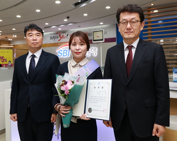 ▲ 지난 29일 SBI저축은행 청담지점 홍명진 주임이 금융감독원이 주관한 ‘2018년도 상반기 전기통신금융사기 피해예방’ 우수 사례로 선정돼 금융감독원으로부터 감사장을 받았다. (사진 오른쪽부터 김수헌 금융감독원 불법금융대응단장, SBI저축은행 청담지점 홍명진 주임, 이명규 금융감독원 금융사기대응팀장)ⓒSBI저축은행