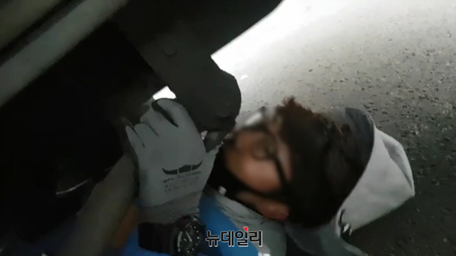 ▲ 택배 트럭 아래 누워 대체인력의 배송을 막는 노조원 ⓒ CJ대리점연합회