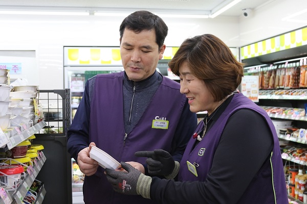 ▲ 김은희 대표점주(오른쪽)와 신태철 점주가 상품 진열을 하고 있다ⓒBGF리테일