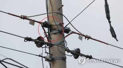 ▲ 5일 오전 전날 고성 산불의 발화지로 추정되는 강원도 고성군 토성면 원암리의 전신주 모습. 화재가 일어난 것으로 추정되는 부분(붉은색 원)이 검게 그을려 있다. ⓒ연합뉴스