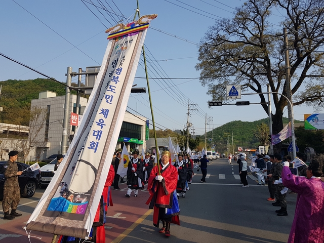 ▲ 도민체전 성화 전국 유일의 발해 대조영 후손들의 집성촌인 송백2리 발해마을에서도 전통 제례 복식과 전통문양이 새겨진 발해마을의 깃발을 들고 성화 봉송에 함께 동참해 관람객의 눈길의 끌었다.ⓒ경산시