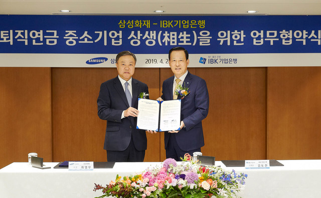 ▲ 24일 을지로 기업은행 본점에서 김도진 기업은행장(오른쪽)과 최영무 삼성화재 사장이 협약식을 마치고 기념촬영을 하고 있다.ⓒ기업은행