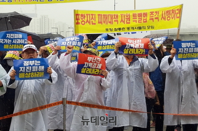 ▲ '포항 11.15범시민대책위원회'와 포항시민 200여명이 비를 맞으며 산업통상자원부를 방문해 항의 집회를 하고 있다.ⓒ뉴데일리