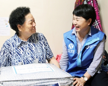 ▲ 신한생명 소속 설계사가 서울 마포구 도화동에 거주하는 독거어르신 가정을 방문해 여름나기 물품이 담긴 행복 바구니를 전달한 후 담소를 나누는 모습.ⓒ신한생명