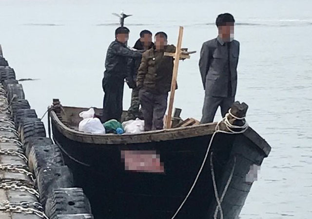 ▲ 삼척항에 입항했을 당시 북한 목선과 선원들. ⓒ뉴시스. 무단전재 및 재배포 금지.
