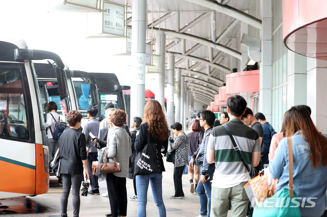 ▲ 추석을 맞아 고향으로 내려가기 위해 고속버스를 기다리는 중인 귀성객들.ⓒ뉴시스