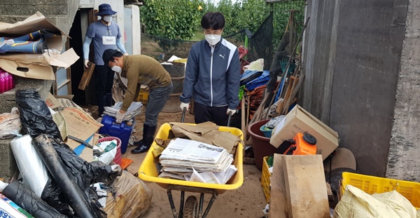 ▲ 8일 충북도청 직원들이 태풍 미탁으로 피해를 입은 경북 영덕군 마을을 찾아 봉사활동을 하고 있다.ⓒ충북도