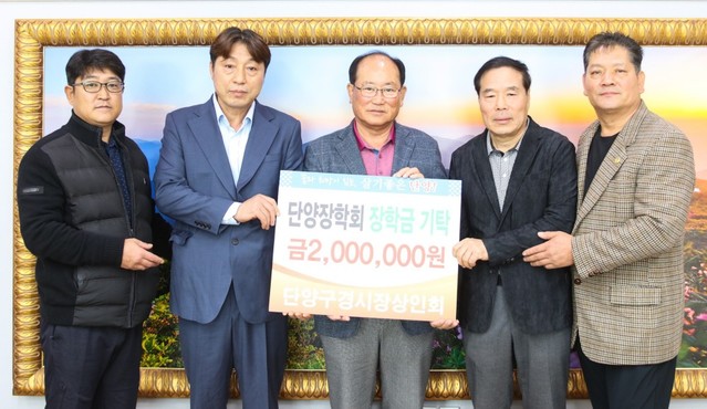 ▲ 지난 30일 안명환 단양구경시장 상인회장(오른쪽 두번째) 등 상인회 임원들이 류한우 단양군수에게 장학금을 전달하고 기념촬영을 하고 있다.ⓒ단양군