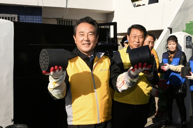 ▲ 김문오 군수(왼쪽)가 지난 8일 관내 저소득 가정을 찾아 사랑의 연탄을 직접 나르며 복지안전망에 최선을 다하겠다고 말했다. ⓒ달성군