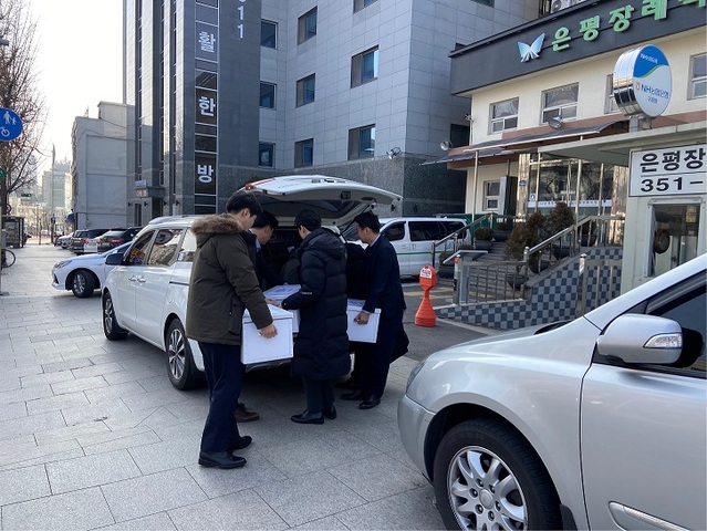 ▲ 롯데건설 관계자들이 9일 서울 은평구 갈현1구역 조합사무실 입구에서 입찰제안서가 담긴 상자를 운반하고 있다. ⓒ 채진솔 기자