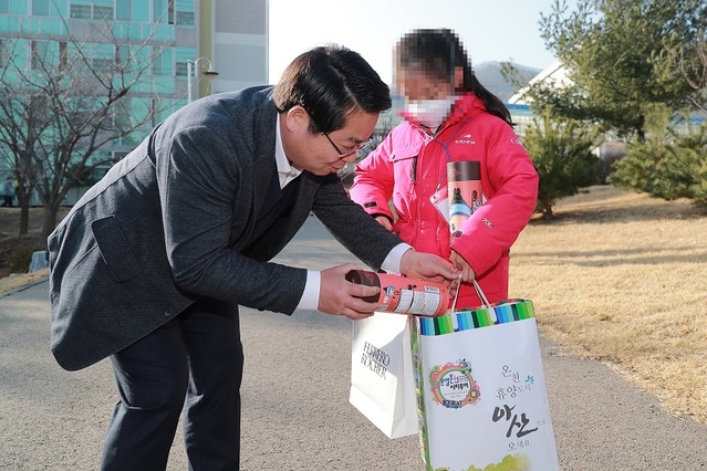 ▲ 오세현 아산시장이 15일 퇴소하는 한 어린이에게 초콜릿을 선물하고 있다.ⓒ아산시