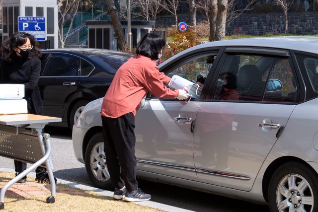 ▲ 세종시 아름중학교가 23일 학교를 찾은 학부모와 학생에게 드라이브 스루 방식으로 교과서를 나눠주고 있다.ⓒ세종시교육청