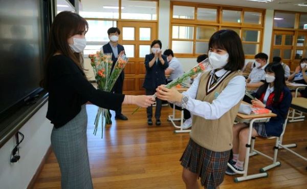 ▲ 세종 도담고등학교가 첫 등교수업을 시작하는 20일 190여 명의 고3 학생들에게 담임교사가 직접 일일이 인사를 나누며 ‘미니장미꽃’을 직접 꽃을 전달했다.ⓒ도담고