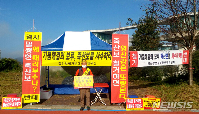 ▲ 죽산보 철거 반대 투쟁위원회 회원이 1인 시위 중인 모습. ⓒ뉴시스