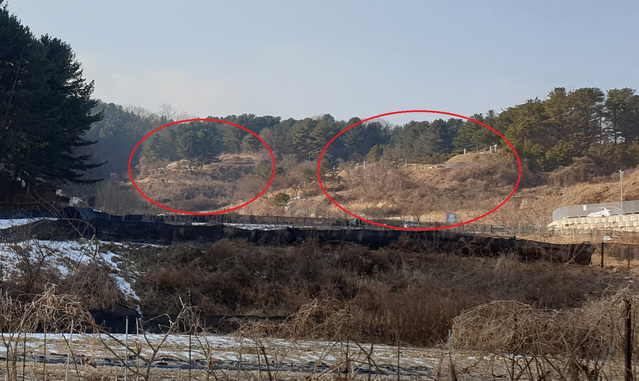 ▲ B건설 공사현장 우측 산에 15기 이상의 묘지가 안장돼 있다. = 박지영 기자