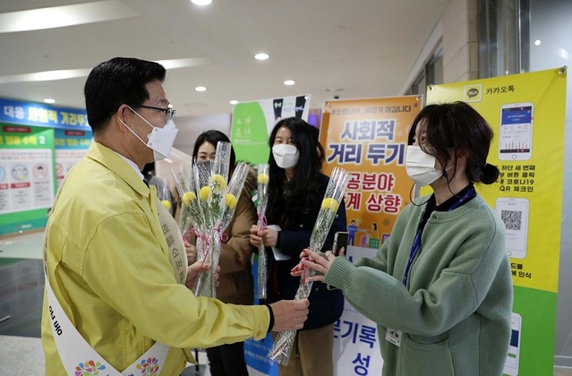 ▲ 양승조 충남도지사가 29일 꽃을 구매한 뒤 한 여직원에게 꽃을 전달하고 있다.ⓒ충남도