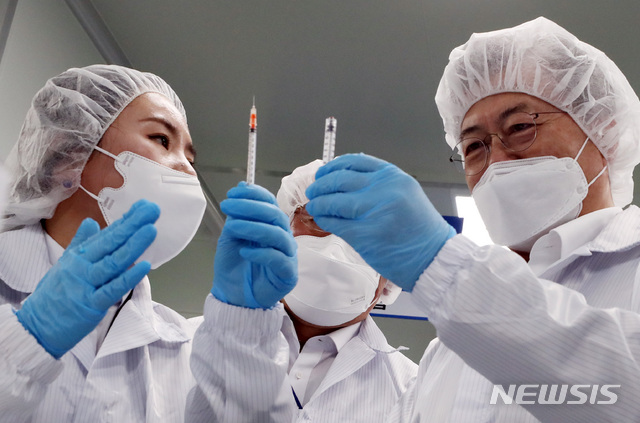 ▲ 문재인 대통령이 18일 오후 전북 군산시 코로나19 백신접종용 최소잔여형(LDS) 백신주사기 생산 현장인 풍림파마텍을 방문해 일반 주사기와 LDS 백신주사기 비교 시연을 하고 있다. ⓒ뉴시스