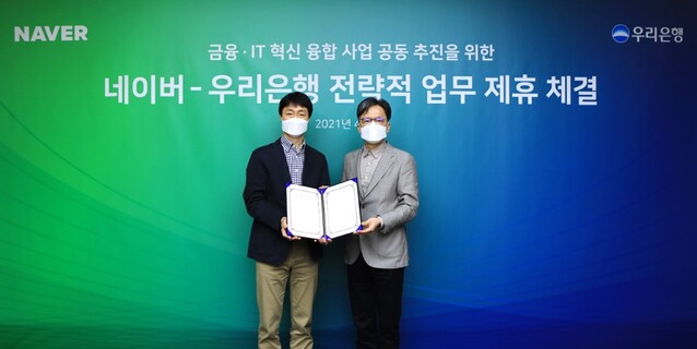 ▲ 우리은행은 경기도 성남시 소재 네이버 본사 그린팩토리에서 네이버와 ‘금융-IT 혁신 융합 사업 공동 추진을 위한 전략적 업무 제휴 협약’을 체결했다. 황원철(오른쪽) 우리은행 DT추진단장이 유봉석 네이버 서비스 운영총괄과 기념촬영을 하고 있다.ⓒ우리은행