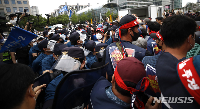 ▲ 전국택배노동조합 조합원들이 15일 오후 서울 영등포구 여의도공원에서 열린 사회적합의 승리, 단협 체결 승리, 전국택배노조 결의대회에 앞서 방송장비를 옮기는 도중 경찰과 충돌하고 있다. ⓒ뉴시스