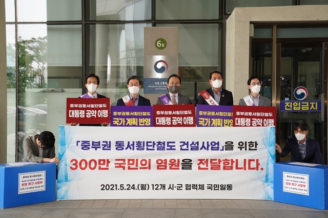 ▲ 지난 5월 24일 중부권 동서횡단철도 건설사업 12개 시장·군수 협력체 대표 박상돈(왼쪽 세번째) 천안시장과 부대표 전찬걸 울진군수, 문경시장, 영주시장, 봉화 군수 등이 국토교통부를 방문해 ‘중부권 동서횡단철도 건설 사업 국가철도망 계획 반영 촉구’ 주민 서명부 제출 기념 촬영을 하고 있다.ⓒ천안시