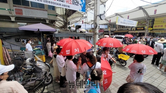 ▲ 서문시장 현장에는 윤석열을 지지하는 열지대 회원들은 ‘공정’과 ‘상식’을 상징하는 붉은색 우산을 들고 환호를 보냈다.ⓒ뉴데일리