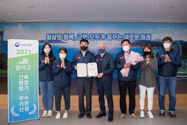 ▲ 이희진 영덕군수(왼쪽에서 세 번째)와 영덕군 도시디자인과 건축디자인팀 직원들이 기념촬영을 하고 있다.ⓒ영덕군