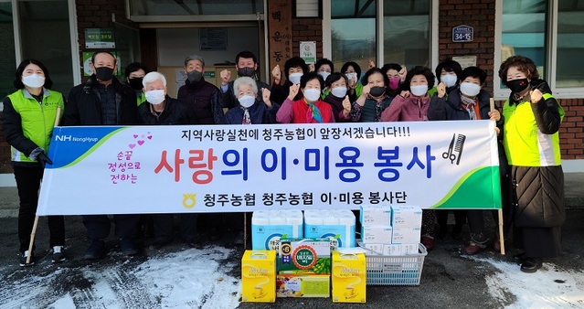 ▲ 이화준 조합장과 박화경 봉사단 회장이 마을 어르신들과 기념촬영을 하고 있다.ⓒ청주농협