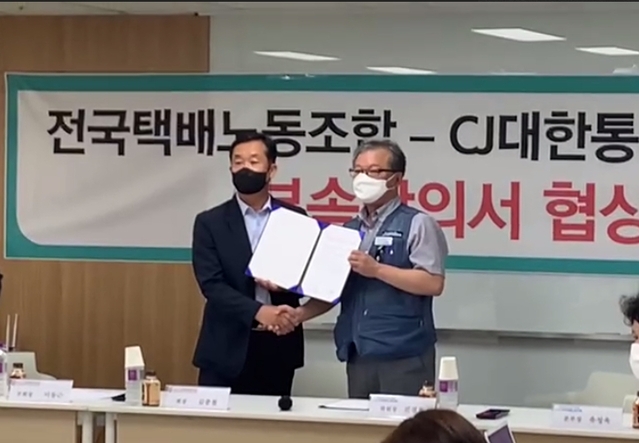 ▲ 18일 오전 서울시 중구 CJ대한통운 택배대리점연합회 사무실에서 열린 'CJ대한통운 택배대리점연합회-전국택배노조 부속 합의서 협상 타결식'에서 김종철(왼쪽) CJ대한통운 택배대리점연합회장과 진경호 전국택배노조위원장이 합의문을 교환하고 있다. ⓒ전국택배노동조합