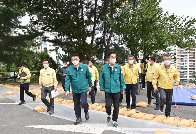 ▲ 임종식 교육감(앞줄 오른쪽)은 지난 14일 제11호 태풍 ‘힌남노’에 따른 집중호우로 본관동 뒤편 사면이 유실된 경상북도 포항시 북구에 위치한 대흥중학교를 방문한 장상윤 교육부 차관과 함께 태풍 피해 현장 긴급복구 관계자들을 격려했다.ⓒ경북교육청