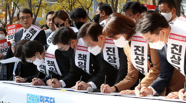 ▲ 이재명 더불어민주당 대표와 의원들이 지난 11일 오후 서울 여의도역 인근에서 열린 이태원참사 국정조사·특검 추진 범국민 서명운동 발대식에서 서명하고 있다. ⓒ뉴시스
