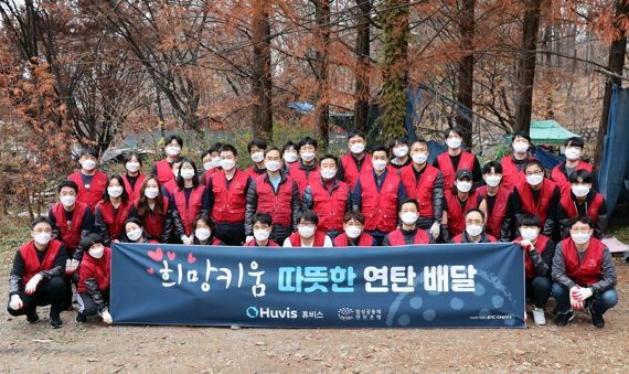 ▲ 휴비스 본사 임직원들이 지난 22일 강남구 구룡마을 일대에 연탄 배달을 마치고 기념 촬영을 하고 있다. ⓒ휴비스 제공
