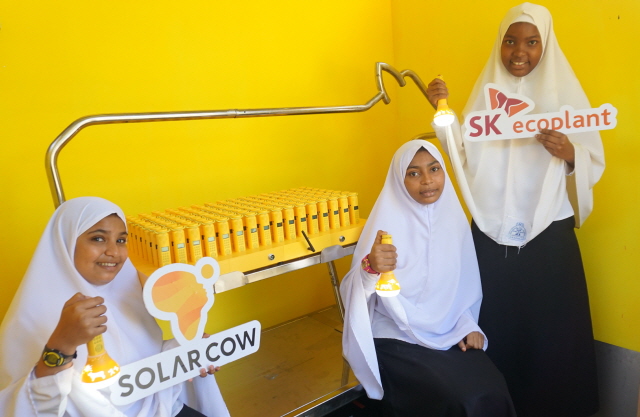 ▲ 탄자니아 학생들이 솔라밀크를 들고 웃고 있다. ⓒSK에코플랜트