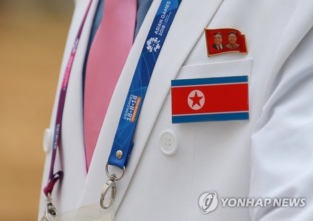 ▲ 북한 선수단 관계자 가슴에 북한 인공기와 함께 김일성-김정일 부자 배지가 부착돼 있다. ⓒ연합뉴스