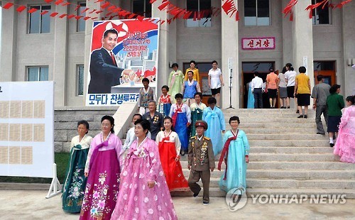 ▲ 북한 인민회의 대의원 선거 모습. 건물에 '모두 다 찬성 투표하자!'라는 내용의 북한의 투표 독려 포스터가 걸려있다. ⓒ연합뉴스