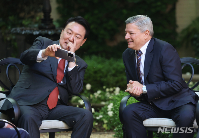 ▲ 미국을 국빈 방문 중인 윤석열 대통령이 24일(현지시간) 워싱턴에 위치한 미국 영빈관 '블레어하우스'에서 열린 글로벌기업 최고경영진 접견에서 테드 서랜도스 넷플릭스 공동 최고경영자와 시구 영상을 시청하고 있다. ⓒ뉴시스